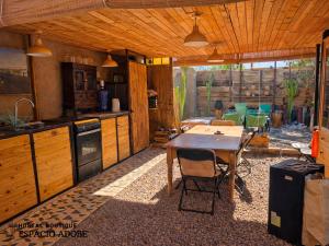 a kitchen with a table and a dining room with at Espacio Adobe - Hostal Boutique in Diego de Almagro