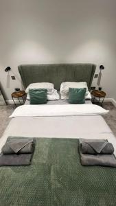 a large bed with two pillows on it in a room at The perfect one bed stay in Central Station