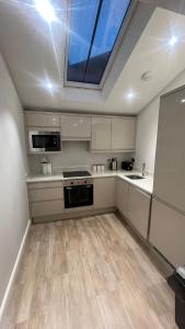 a large kitchen with a skylight in the ceiling at The perfect one bed stay in Central Station