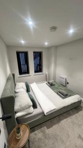a large bed in a room with a table at The perfect one bed stay in Central Station