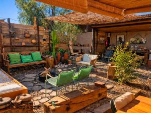 a patio with chairs and a couch and a table at Espacio Adobe - Hostal Boutique in Diego de Almagro
