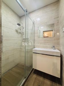 a bathroom with a glass shower and a sink at Jonny room in Trnávka