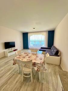 a living room with a table and a couch at La Mer Prime Time in Varna City