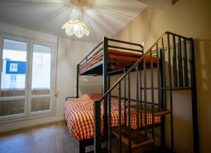 a room with a bunk bed and a staircase at Le #7 - Centre ville - Parking privé - Balcon in Saint-Omer