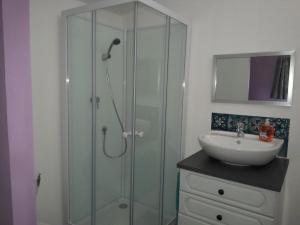 a bathroom with a glass shower and a sink at 35 m2 independent studio in Marillet