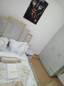 a bedroom with two beds and a painting on the wall at Wema m stays in Munyu