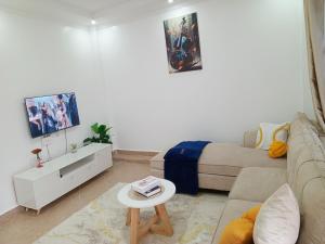 a living room with a couch and a table at Wema m stays in Munyu