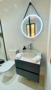 a bathroom with a sink and a toilet and a mirror at B's House in Pointe-à-Pitre
