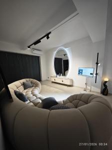 a living room with two couches and a mirror at B's House in Pointe-à-Pitre +23 photos