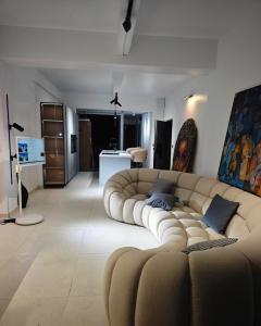 a living room with a large couch in the middle at B's House in Pointe-à-Pitre