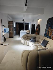a living room with a large couch in the middle at B's House in Pointe-à-Pitre