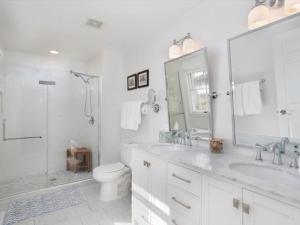 a bathroom with two sinks and a shower and a toilet at Covey Creek in Saint Michaels +59 photos