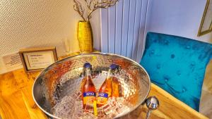 two bottles of beer in a bowl on a table at AMORE 66 bei Greta in Marl +12 photos