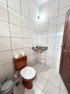 a small bathroom with a toilet and a sink at Pousada Morada Nobre in Barreirinhas +39 photos