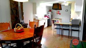a kitchen with a wooden table and a dining room at Casa Blanca Hotel Campestre in Francisco Zarco +15 photos