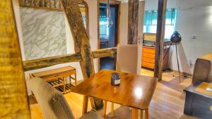 a living room with a wooden table and chairs at bei GRETA Wohnung 77 in Marl