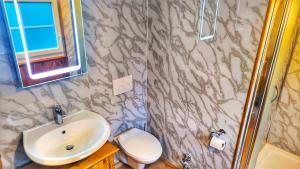a bathroom with a sink and a toilet at bei GRETA Wohnung 77 in Marl +7 photos