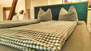 two beds with checkered pillows on top at bei GRETA Wohnung 77 in Marl