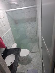 a bathroom with a shower and a toilet and a sink at Apto 04 em São Bras in Belém