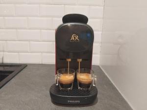 a coffee maker with two glasses on a counter at Iglu in Villeneuve-le-Roi +12 photos