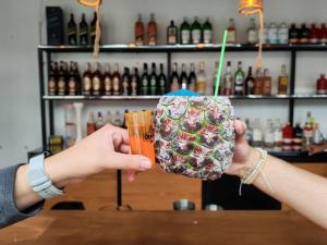two people holding a drink in their hands at Hostal Distrito in Sucre