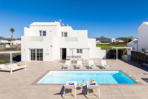 a villa with a swimming pool in front of a house at Villa Yaiza Secret 1 in Yaiza