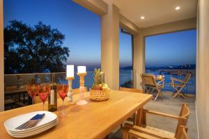 a dining room with a table with wine glasses at Irida sunset in Pentátion