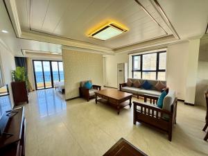 a living room with a couch and a table at Seaview Garden Hotel & Residences in Trinity