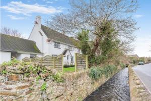 a house with a stone wall next to a river at 3 Bed in Croyde oc-s34664 in Croyde