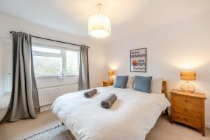 a bedroom with a large white bed and a window at 3 Bed in Croyde oc-s34664 in Croyde