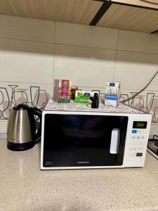 a microwave sitting on top of a counter at Sunset Home Apartment in Galaţi
