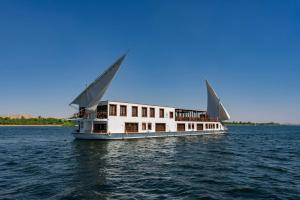 a boat in the water on the water at Princess Farida Luxury Dahabiya Nile Cruise, Every Monday from Luxor to Aswan 4 nights and Every Friday from Aswan to Luxor 3 nights in Luxor +44 photos