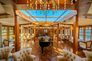 a dining room with tables and chairs and a chandelier at Princess Farida Luxury Dahabiya Nile Cruise, Every Monday from Luxor to Aswan 4 nights and Every Friday from Aswan to Luxor 3 nights in Luxor