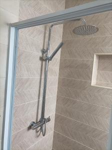 a shower with a glass door in a bathroom at LBranco in Porto Novo +2 photos