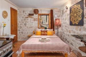 a bedroom with a large bed with yellow pillows at HealthyStudio512 Apartments in Kotor