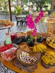 a table with a bunch of food and flowers on it at Pietra Hotel in Sáchica +55 photos