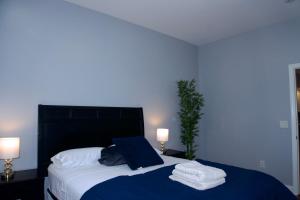 a bedroom with a large bed with towels on it at New York Private Room 32 in West New York +15 photos