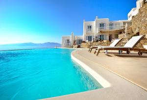 a swimming pool in front of a villa at Boutique Villa Aquata Private pool in Mikonos