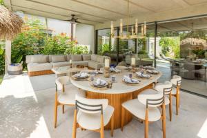 a dining room with a table and chairs at Luxury 5BR Villa with Pool Jacuzzi 2 Golf Carts in Punta Mita