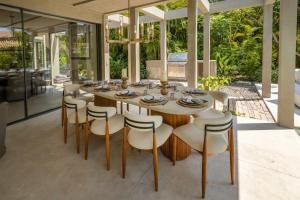 a dining room with a table and chairs at Luxury 5BR Villa with Pool Jacuzzi 2 Golf Carts in Punta Mita