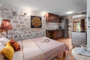 a bedroom with a large bed and a kitchen at HealthyStudio512 Apartments in Kotor