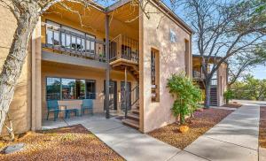 a house with a balcony and a table and chairs at Cowboy Hideout in Sedona