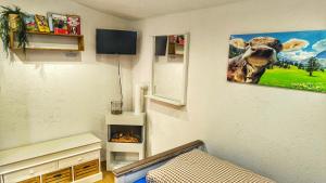 a room with a fireplace and a picture of a cow at STUGA bei GRETA in Marl