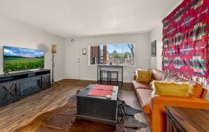 a living room with a couch and a flat screen tv at Cowboy Hideout in Sedona