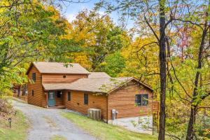 a cabin in the woods with a gravel road in front at Healing House - Healing Escape in Berkeley Springs
