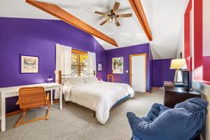 a purple bedroom with a bed and a chair at Healing House - Healing Escape in Berkeley Springs