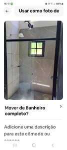 a bathroom with a glass door in a room at Loft centro do universo in Arroio do Sal