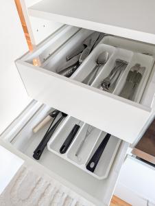 a white drawer filled with kitchen utensils at Private Studio with Bathroom and Kitchen, Central Location in Tromsø