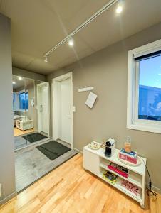 a bathroom with a walk in shower and a table at Private Studio with Bathroom and Kitchen, Central Location in Tromsø