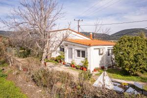 a small white house with an orange roof at Beautiful cottage house at Mesokampos in Samos